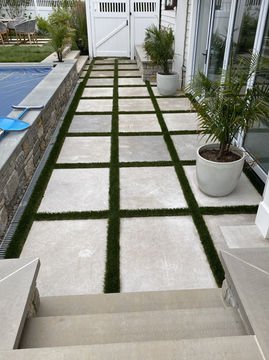 Elegant patio pathway with large square pavers and green turf strips. Residential landscaping near me| Down To Earth Landscaping | Jackson New Jersey, USA (732) 833-7702