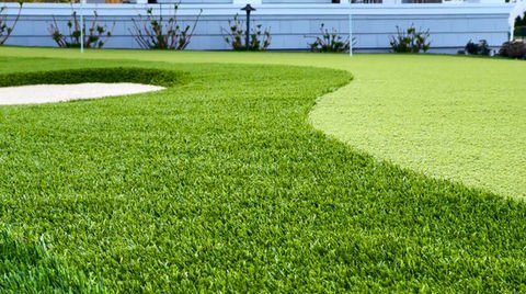 Artificial turf putting green, sand trap, modern home background. Residential landscaping near me| Down To Earth Landscaping | Jackson New Jersey, USA (732) 833-7702