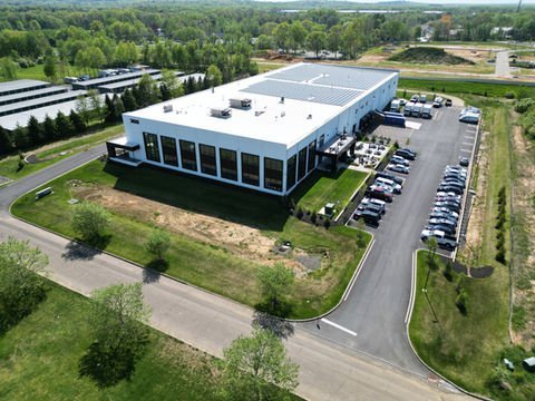 Modern white commercial building, large parking lot, green landscape, aerial view. | Down To Earth Landscaping | Jackson New Jersey, USA (732) 833-7702