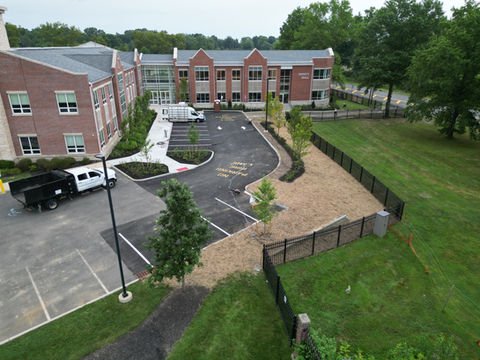 Aerial view of brick building, new parking lot, landscaping, trucks, green grass. | Down To Earth Landscaping | Jackson New Jersey, USA (732) 833-7702