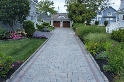 Long paver stone driveway leading to two-car garage, landscaped yards. Residential landscaping near me| Down To Earth Landscaping | Jackson New Jersey, USA (732) 833-7702