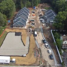 Aerial view new housing development, gray-roofed homes, and retention pond construction. | Down To Earth Landscaping | Jackson New Jersey, USA (732) 833-7702
