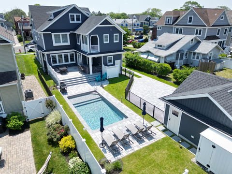 Beautiful dark blue house, large backyard, sparkling swimming pool, lounge chairs. Residential landscaping near me| Down To Earth Landscaping | Jackson New Jersey, USA (732) 833-7702