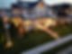 Elegant multi-story house with expertly installed Night Lighting, beautifully maintained green lawn, American flag. | Down To Earth Landscaping | Jackson New Jersey, USA (732) 833-7702