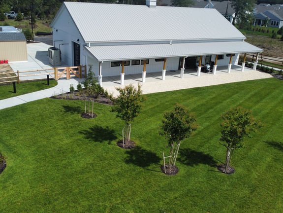 White modern ranch building, covered porch, inviting green lawn and path. Commercial landscaping near me | Down To Earth Landscaping | Jackson New Jersey, USA (732) 833-7702